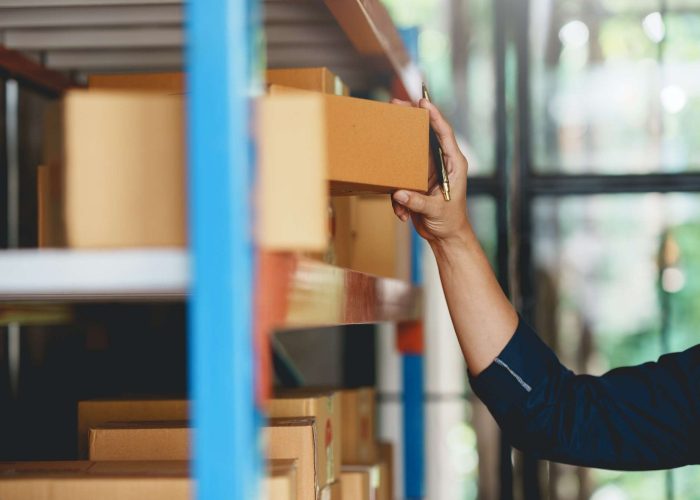 Male warehouse check worker checking and counting inventory accurately and tidy by balance.